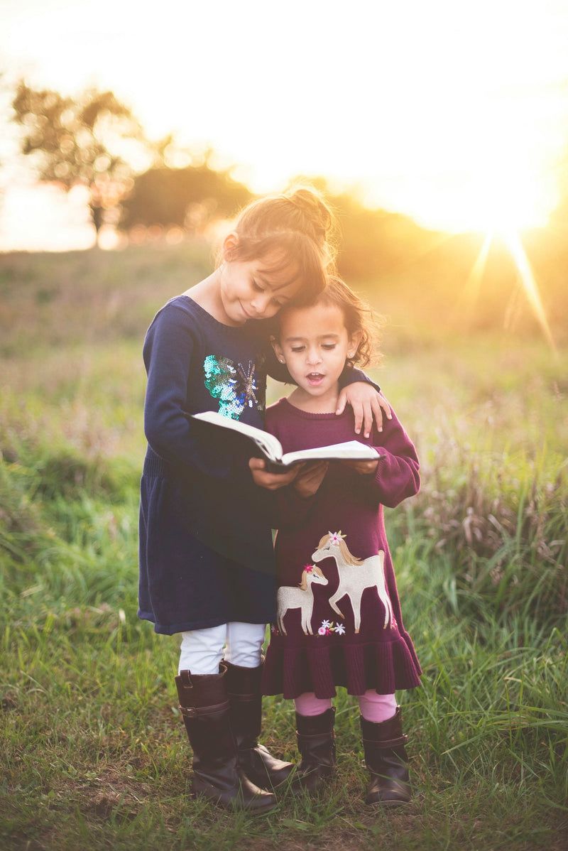 A woman and a little girl reading together, gifts for grandparents