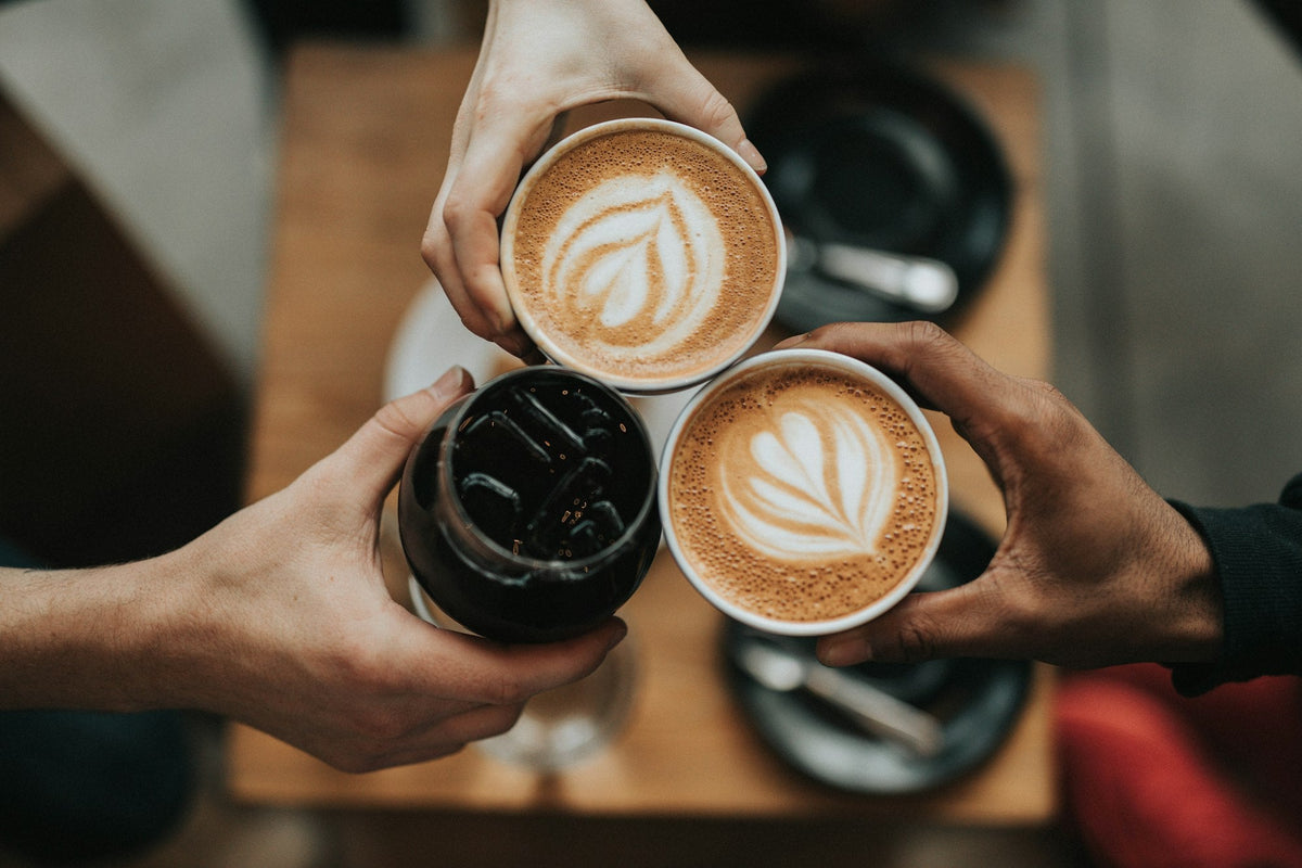Personalized drinkware: friends raising coffee cups