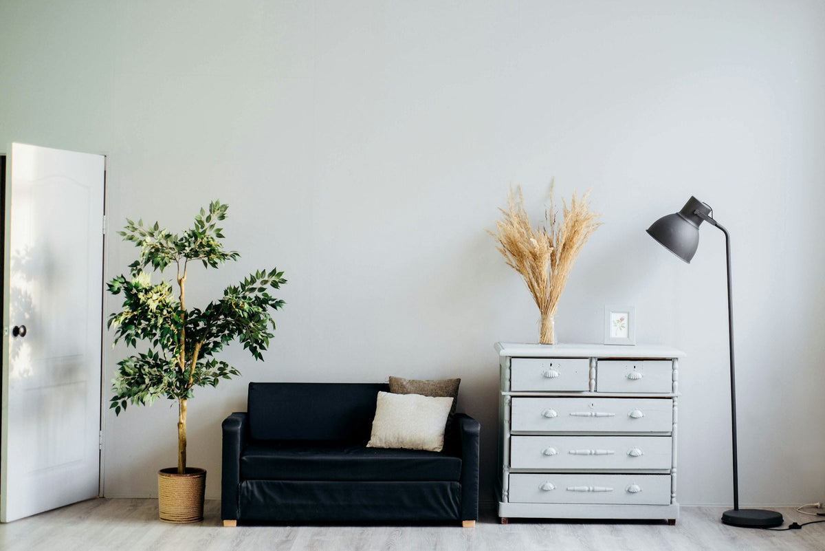 A bright living room with a sofa and pillows, personalized home gifts