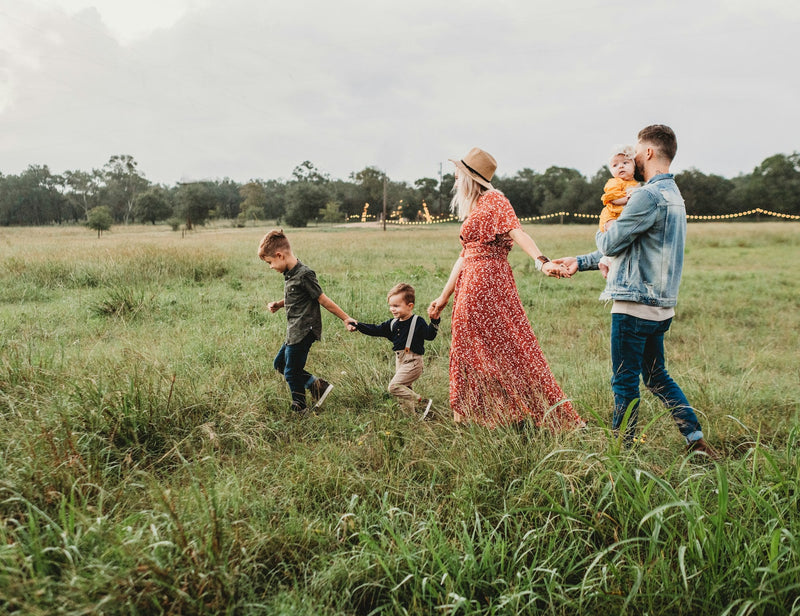 A family walking hand in hand through a field, personalized Father's Day gifts