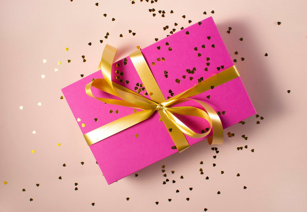 Personalized gifts: a wrapped gift box with a gold ribbon